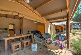 Tenda safari Blokhut Cotton Comfort presso Flower Camping Le Bel Air in Francia con patio e arredi in legno.