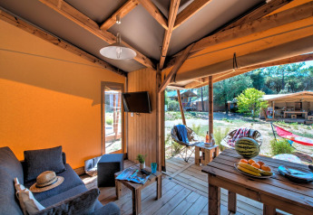 Intérieur de la tente safari Blokhut Cotton Comfort au Flower Camping Le Bel Air en France, avec terrasse confortable.