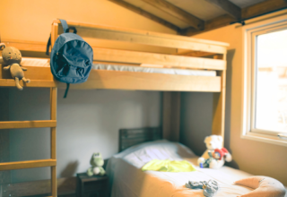 Room with bunk bed and single bed at Lodge VIP Premium in Flower Camping La Chênaie, France.