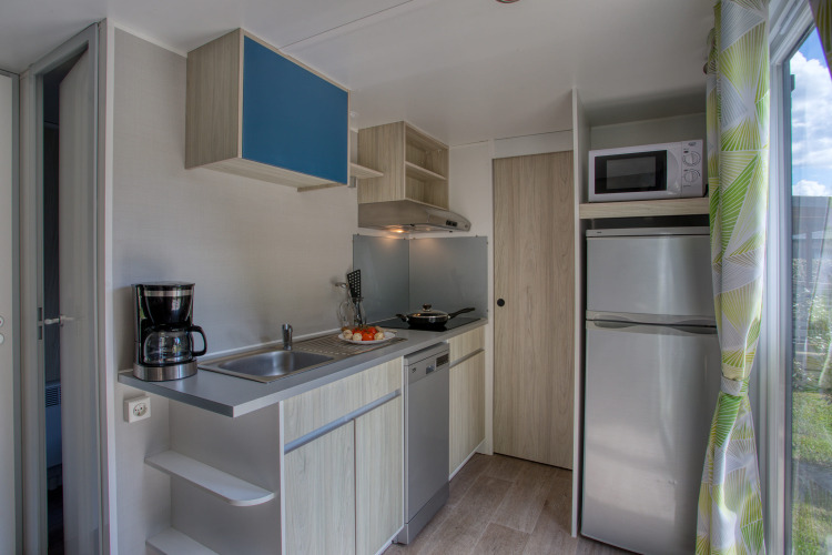 Cucina moderna dello Stacaravan Campbell Premium al Flower Camping La Sagne in Francia, completamente attrezzata.