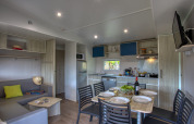 Sala y cocina modernas de una Stacaravan Arlequin Premium en Flower Camping La Sagne, Francia.