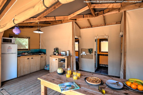 Interior view of a comfortable safari tent, Ecolodge Cotton Toilée CONFORT, at Flower Camping Le Conleau, France.