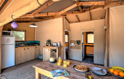 Interior view of a comfortable safari tent, Ecolodge Cotton Toilée CONFORT, at Flower Camping Le Conleau, France.