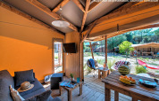 Interior photo of an Ecolodge Cotton Toilée CONFORT safari tent terrace at Flower Camping Le Conleau in France.