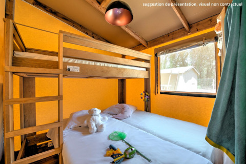 Interior view of Ecolodge Cotton Toilée COMFORT safari tent at Flower Camping Le Conleau in France.