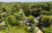 Luftaufnahme von Stacaravan Confort Hütten bei Camping Demoiselles Plage, umgeben von Bäumen in Frankreich.