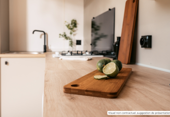 Cuisine moderne de lodge avec des citrons verts tranchés sur planche au Homeflower Premium 1 kamer, Flower Camping Les Dunes.