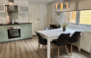 Cucina luminosa e zona pranzo al Cozy Lodge, Bungalowpark Het Verscholen Dorp, Paesi Bassi, stile moderno.