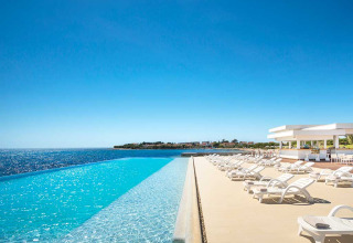 Infinity pool og solsenge ved Aminess Planet Camping Sirena i Istrien, Kroatien, med udsigt over det klare hav.