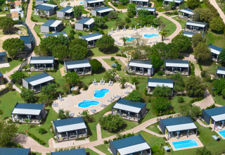 Aerial view of Aminess Planet Camping Sirena in Istria, Croatia, showing bungalows, paths, and swimming pools.