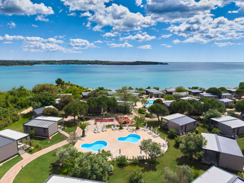 Aerial view of Aminess Planet Camping Sirena holiday park with cabins, pool and sea in Istria, Croatia.