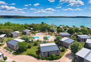 Scenic view of Aminess Planet Camping Sirena holiday park in Istria, Croatia, with cabins, pool and sea.