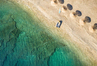 Vista aerea di Aminess Planet Camping Sirena con ombrelloni e acqua cristallina sulla spiaggia in Istria.