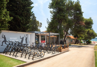 Sport center at Aminess Planet Camping Sirena in Istria, Croatia, with bikes for rent and trees nearby.