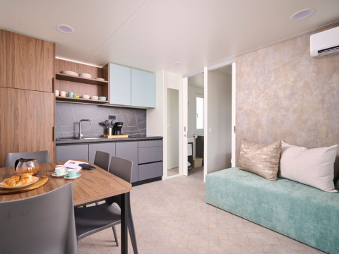 Interni moderni di una Premium Holiday Home all'Aminess Planet Camping Sirena in Croazia, cucina e divano.