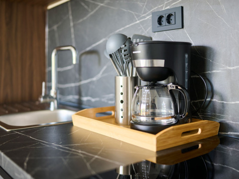 Cucina di casa vacanze moderna con macchina da caffè e utensili su vassoio ad Aminess Planet Camping Sirena, Croazia.