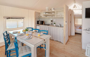Innenaufnahme des Maro Premium Glamping Zeltes bei Valamar Camping Lanterna in Kroatien mit Küche und Esstisch.