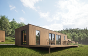 Moderne houten lodge bij Eco Lodge in Hameau de l'Ourthe, België, met terras en groene omgeving.