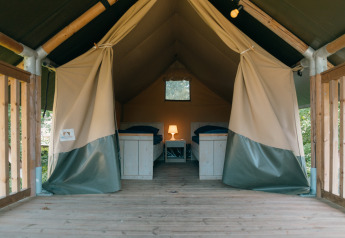 Intérieur d'une tente Safaricottage XS avec deux lits simples au Holiday Park Sallandshoeve aux Pays-Bas.