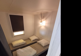 Interior view of a Coco Sweet safari tent with bathroom at Camping Floreal La Roche-en-Ardenne in Belgium.