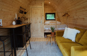Interior view of Glamping Pod met Sauna at REBL Outdoor in the Netherlands, with modern wood decor.