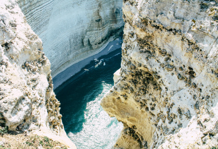 Dramatic view of steep cliffs and blue seawater on the coast near Yport, Normandy, France.