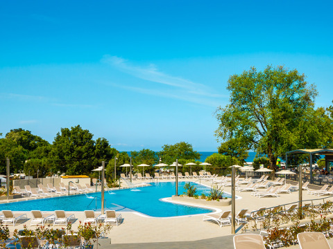 Swimming pool area with loungers at Aminess Planet Camping Maravea Resort, a holiday park in Istria, Croatia.