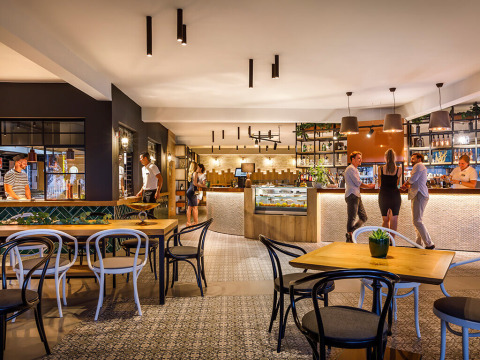 Modern restaurant and bar area at Aminess Planet Camping Maravea Resort in Istria, Croatia, with guests.