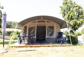 Nommerlayen Lodge presso Camping Nommerlayen in Lussemburgo, terrazza coperta con sedie e tavolo.