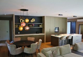 Moderne keuken en eetruimte in Forest Lodge Deluxe, Holiday Park BreeBronne, met stijlvol interieur.