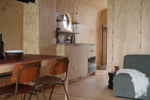 Interior view of the Wrap house with sauna and bathtub at Resort de Parel, Netherlands, wooden decor.