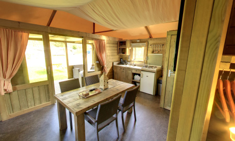 Interior of the Kampeerlodge at Familievakantiepark Krieghuusbelten in the Netherlands, showing kitchen and dining area.