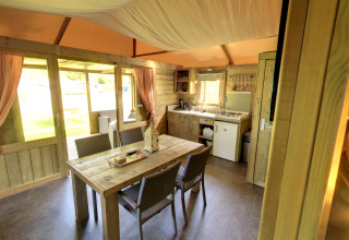 Interior of the Kampeerlodge at Familievakantiepark Krieghuusbelten in the Netherlands, showing kitchen and dining area.