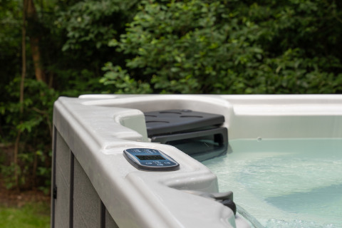 Outdoor jacuzzi at Lodge with Jacuzzi at Woodz Lodges in Belgium with control panel on the edge.