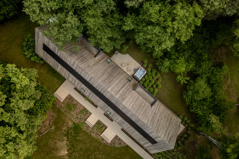 Aerial view of the Wellness Suite at Woodz Lodges in Belgium, surrounded by lush trees and greenery.