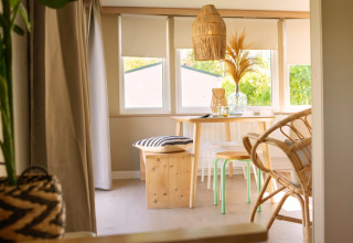 Bright, cozy dining area in a tiny house at Zomerhuisjes, Beloofde Land, Netherlands.
