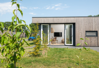 Moderne Holz-Lodge namens Oak Lodge im Vakantiepark Hölte, Niederlande, mit offenem Wohnbereich.