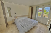 Bedroom of Cottage PMR for disabled guests at Camping Seasonova Le Point du Jour in France, accessible design.
