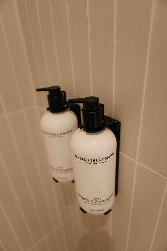 Two mounted Marie-Stella-Maris soap dispensers in the bathroom of LumiPod with hot tub at Wilsumer Berge, Germany.