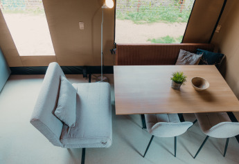 Overhead view of dining area in Wander Lodge at Holiday park De Boshoek, Netherlands, with modern decor.