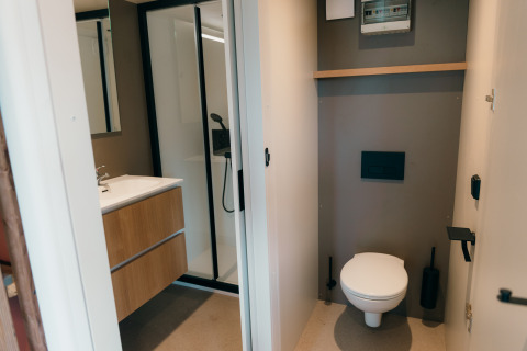 Modern bathroom and toilet at Wander Lodge, Holiday park De Boshoek, Netherlands, with minimalist interior.