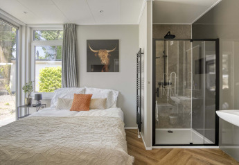 Helles Zimmer in Veluwehoeve, Bospark Ede, mit Doppelbett, modernem Duschbad und großen Fenstern.