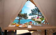 Breakfast inside a safari tent at Camping Arena One 99 Glamping, Croatia, overlooking the beautiful sea.