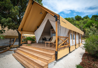 A luxurious glamping tent with a wooden terrace and hammock at Camping Arena One 99 Glamping in Istria, Croatia.