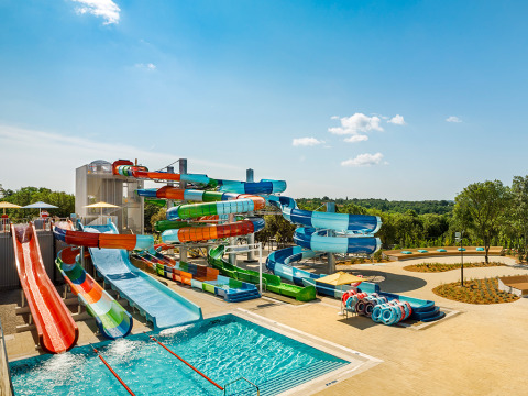 Colorful waterslides and pool at Valamar Camping Istra holiday park in Istria, Croatia on a sunny day.