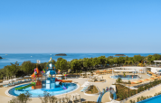 View of Valamar Camping Istra holiday park with water slides, pools, and sea view in Istria, Croatia.