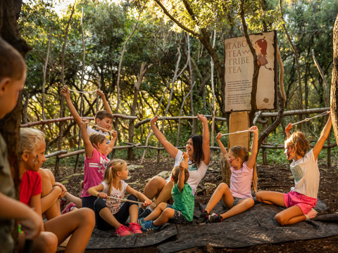 Children enjoy group activities with an adult in a forest area at Valamar Camping Istra, Istria, Croatia.