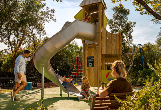 Family enjoying playground fun at Valamar Camping Istra holiday park, featuring a slide in Istria, Croatia.