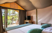 Interior of a Mini Lodge safari tent at Camping Arena One 99 Glamping in Croatia, featuring a double bed.