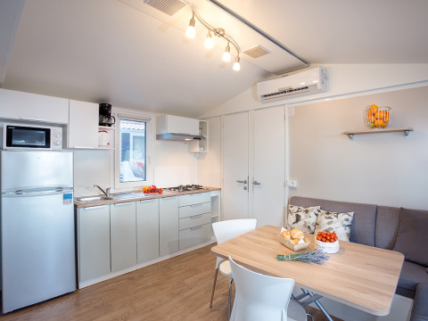 Modern kitchen and dining area at Ježevac Home, Valamar Camping Ježevac, Croatia, with stylish decor.